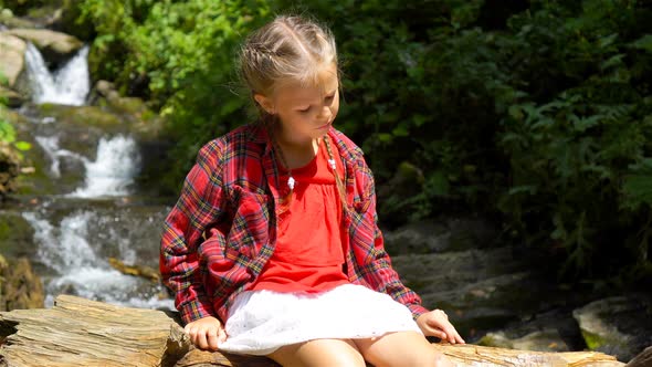 Little Girl Enjoying View of Waterfall in Krasnay Poliana
