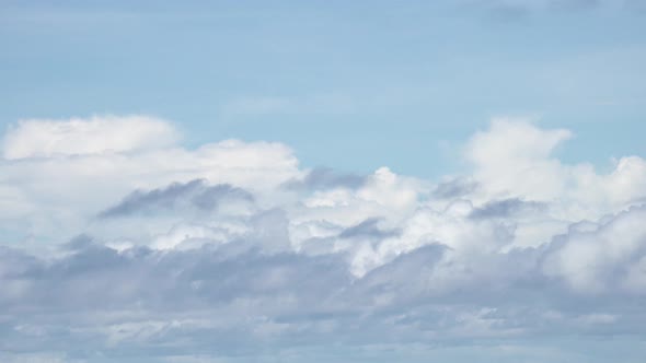 4K timelapse beautiful white cloudsing fast on a blue sky summer day. alt