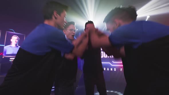 Male Gamers Staking Hands Together alt