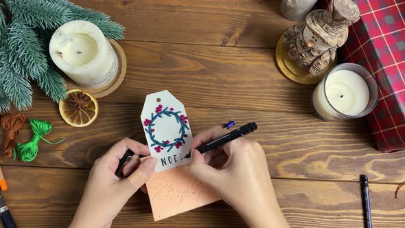 Woman Write Inscription with Marker on Label for Decorating Gift