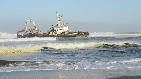 Sunken Ship in the Ocean Breakers Grounded at Namibia Coastline