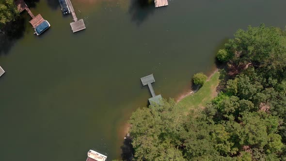 Slow aerial zoom in of dock on lake. alt