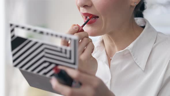 Unrecognizable Slim Young Businesswoman Applying Red Lipstick Indoors alt