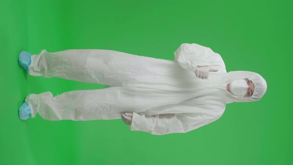 Asian Male Wear Protective Uniform PPE And Showing Thumbs Up In Green Screen Studio alt