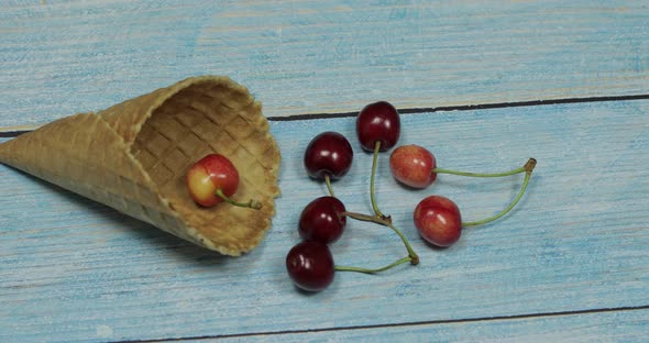 Berry Ice Cream. Berries of Cherry in a Waffle on a Blue Wooden Background alt
