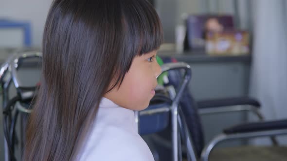 Hairdresser makes hairstyles for cute little girls. cute little girl cutting bangs. alt