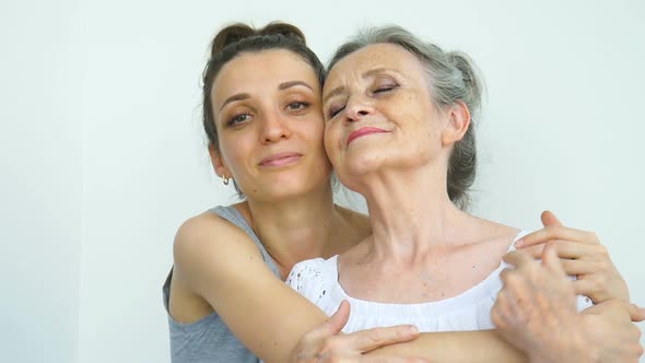 Happy Senior Mother is Hugging Her Adult Daughter the Women are Laughing Together Sincere Family of alt