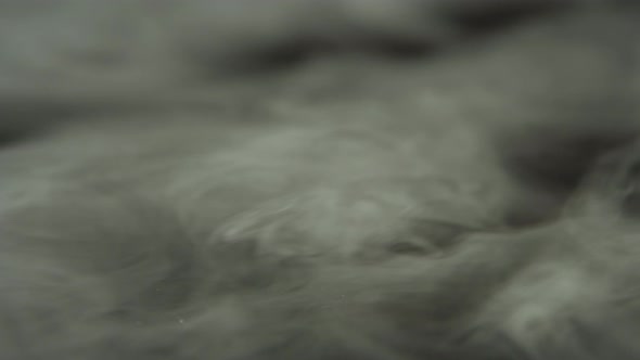 Dry Ice, Smoke, Vapor, Fog, Cloud at Dark Background. Closeup alt