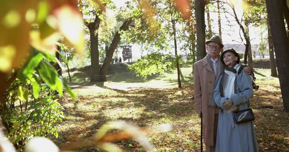 Portrait of Married Couple Stands in Embraces Together Talks and Admires Autumn alt