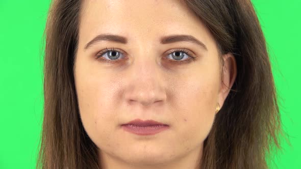 Girl Is Looking Straight and Smiling. Close Up. Green Screen alt