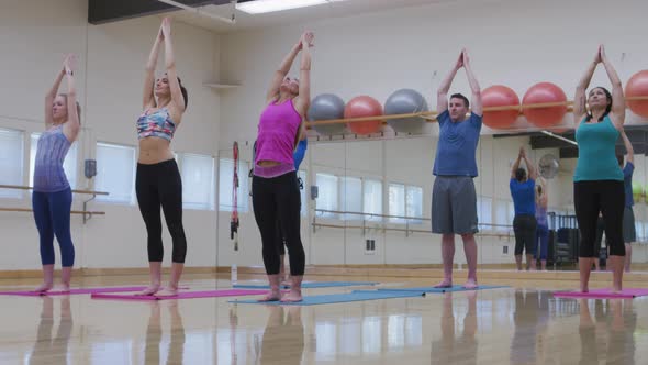 Group of people doing yoga at studio