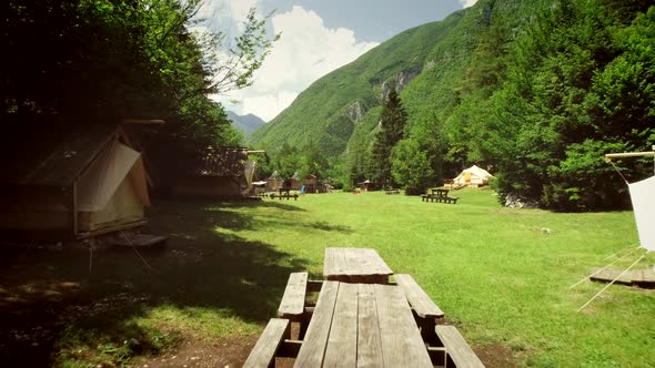 Aerial view of a summer camp with cabins and recreational area in the forest. alt