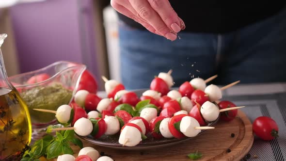 Salting Caprese Canapes with Cherry Tomatoes and Mozzarella Cheese Balls alt