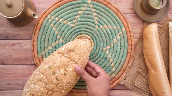 Putting Whole Meal Bread on Table alt
