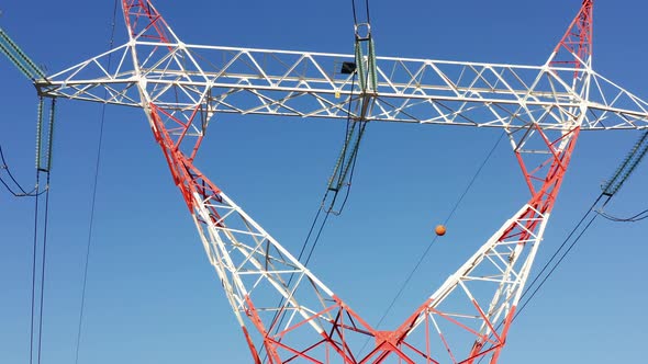 Transmission tower supporting an overhead high voltage power line - close up alt