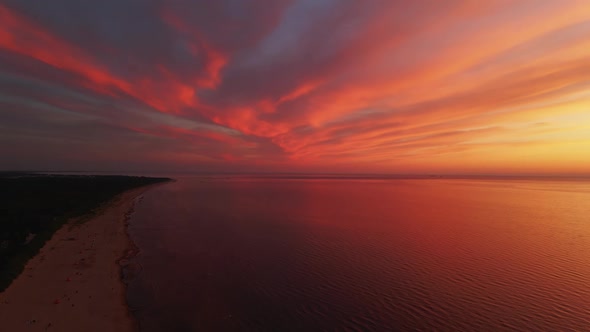 Aerial Scenic Sunset Unreal View Over Rare Red and Orange Sky Above Beautiful Reflecting Sea and alt