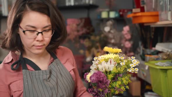 Florist Woman Make a Bouquet of Beautiful Flowers. Floral Art Concept. Working Girl in Store.