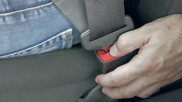 Male Hand Unfastening Car Safety Seat Belt