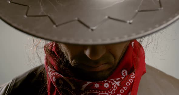 Portrait footage of a gunslinger looking from under his hat, 4k alt