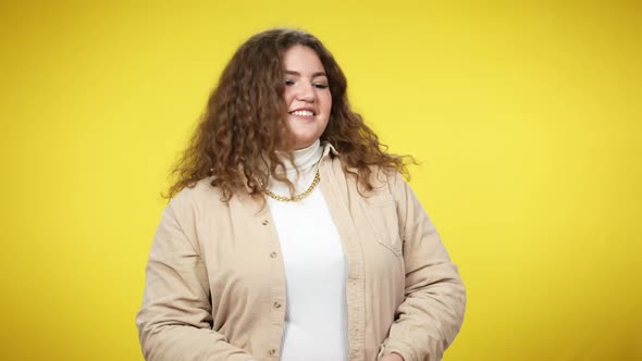 Smiling Charming Woman Catching Gifts Posing at Yellow Background alt