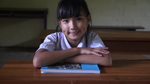 Little Girl Student Smiling In Classroom alt