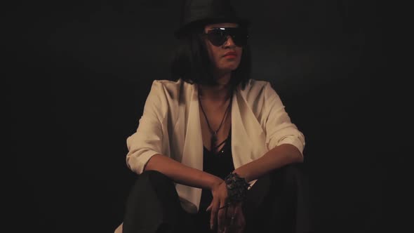 Woman Sitting in Hat and Glasses