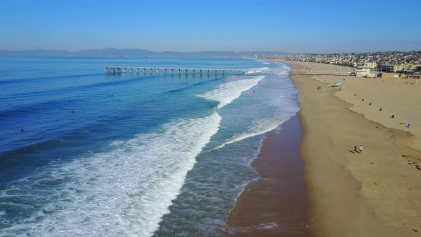 Aerial drone uav view of a pier over the beach and ocean. alt