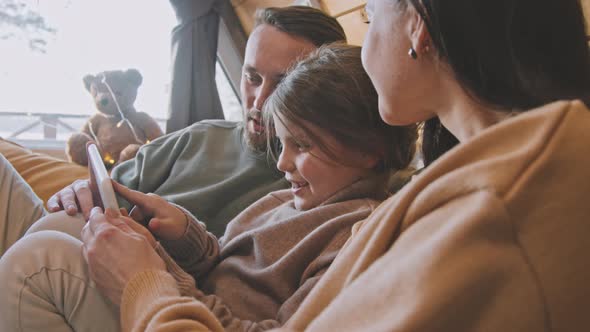 Parents and Daughter Using Tablet alt