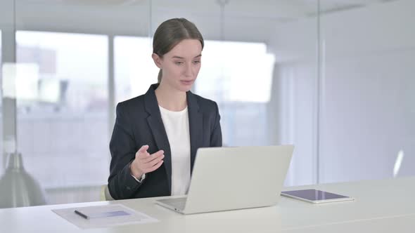 Cheerful Young Businesswoman Doing Video Chat on Laptop alt