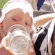 Baby girl drinking water from bottle outdoor - VideoHive Item for Sale