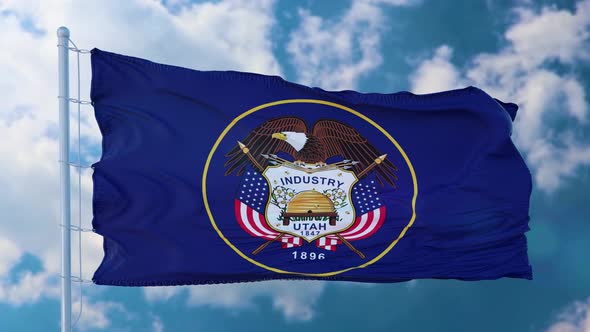Utah Flag Waving in the Wind Blue Sky Background alt
