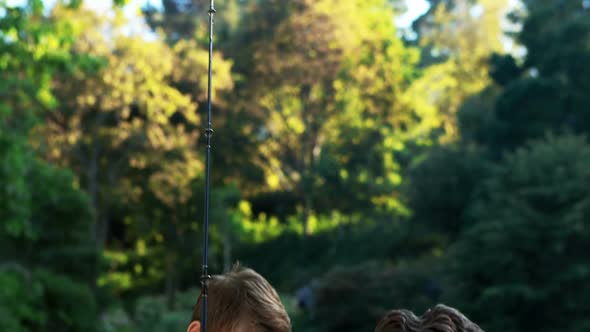 Father and son interacting with each other in the park alt