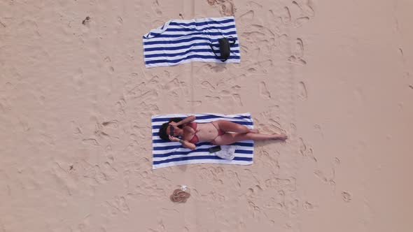 Drone Ofwoman In Bikini On Beach And Putting On Sunglasses alt