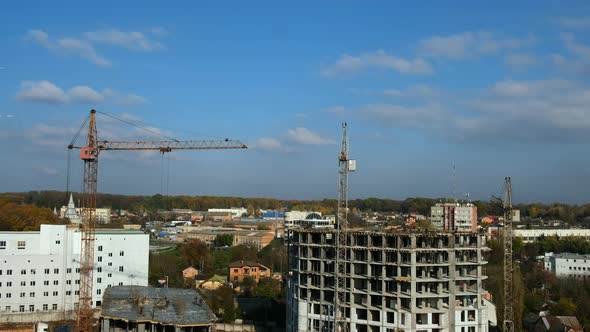 Time lapse builders and cranes working on the construction site 