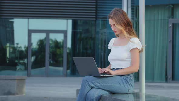 Focused Attractive Woman Journalist Freelancer Working Online Using Laptop Sitting Outdoor Looking alt