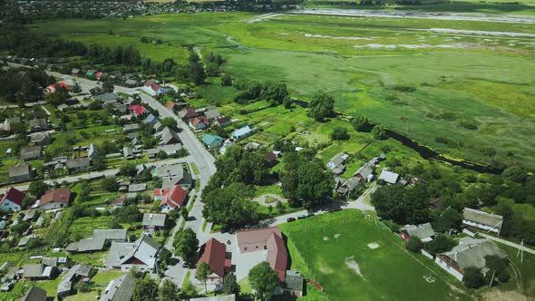 Flight over a provincial town. Multi-colored roofs of houses are visible. Aerial photography. alt