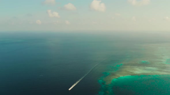 Seascape Coral Reef and Blue Sea with Motorboat alt