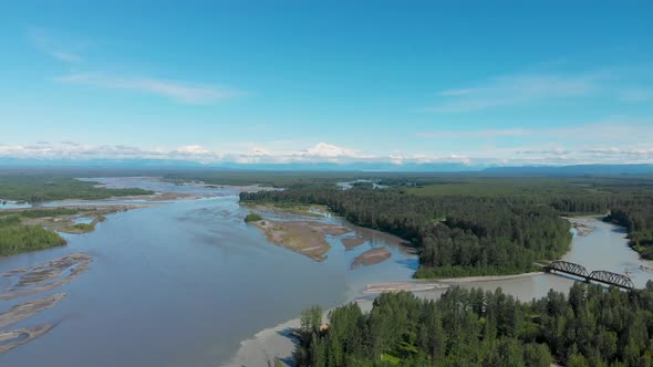 4K Drone Video of Alaska Railroad Train Trestle with Mt. Denali in Distance during Summer alt