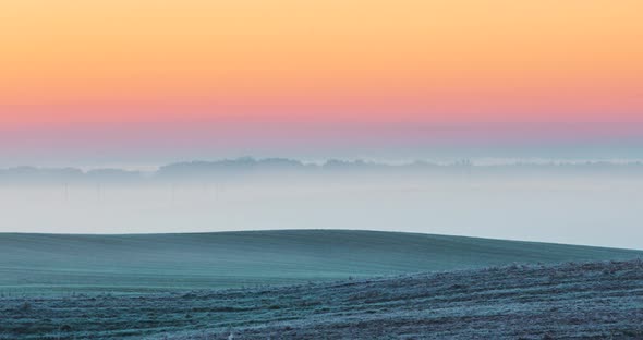 Hazy Morning Fog with Frozen Meadows Colorful Morning Sky and Slowly Moving Fog in the Fields