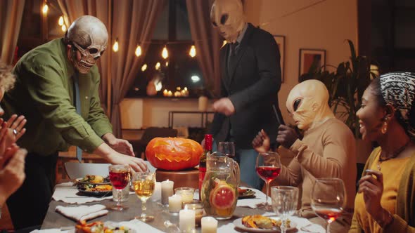 Friends Having Fun at Halloween Dinner Party alt