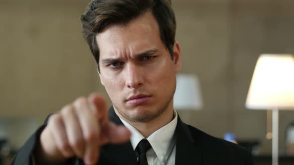 Angry Man Pointing toward Camera with Finger alt