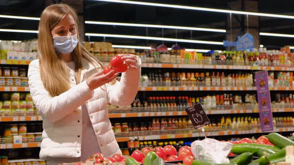 The girl buys tomatoes in the supermarket, natural products alt