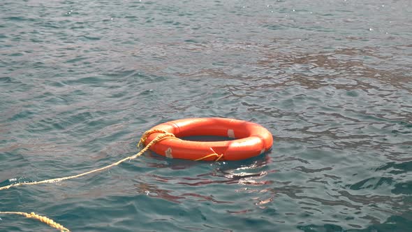 a Lifebuoy Sways on the Waves in the Sea, Serves To Save People Who Have Fallen Into the Water alt