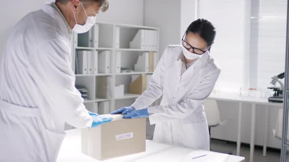 Doctors with Box of Covid-19 Vaccines alt