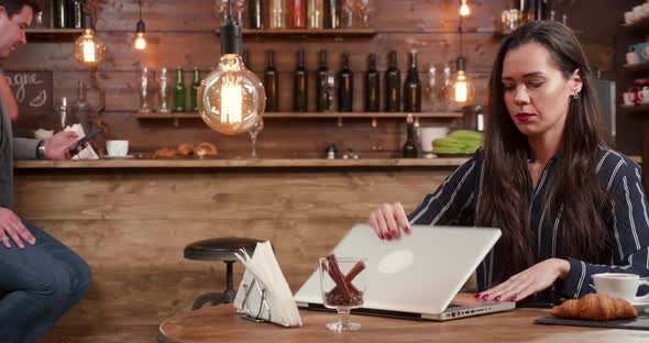 Stylish Young Woman Asking the Bartender for the Bill and Making the Payment alt