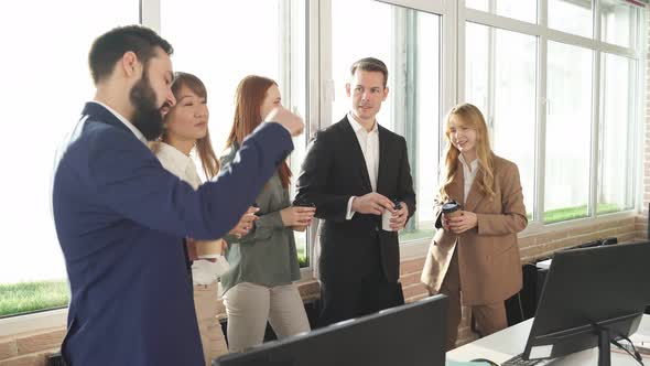 Group of Young Managers Communicating During Meeting