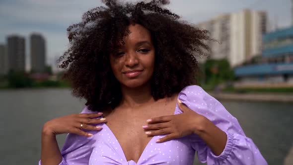 Happy Young Afro-american Woman Is Dancing Joyfully in Cityscape at Summer Day alt