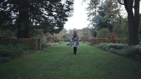 Woman Running Away In Park