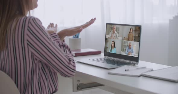 Back View of Female Employee Speak Talk on Video Call with Diverse Multiracial Colleagues on Online alt