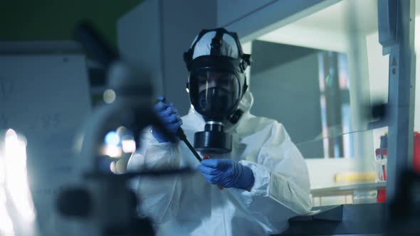 Person in Hazmat Works in Laboratory with Coronavirus. alt